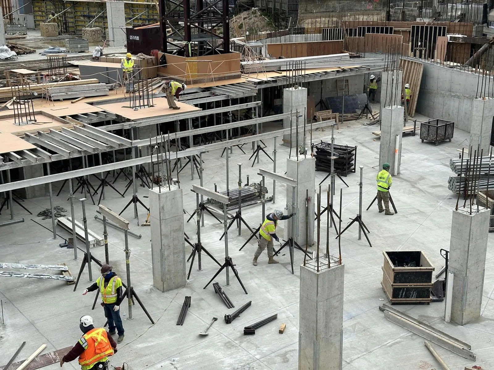 Crew working on a shored concrete deck, seen from above