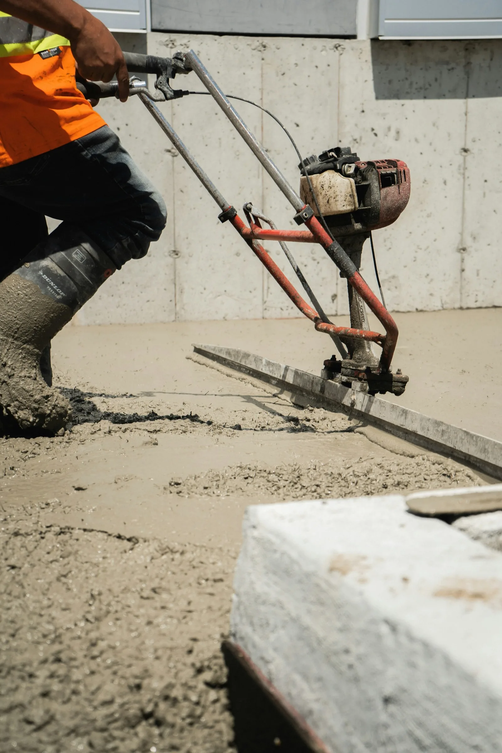 Power screed on a freshly poured concrete slab