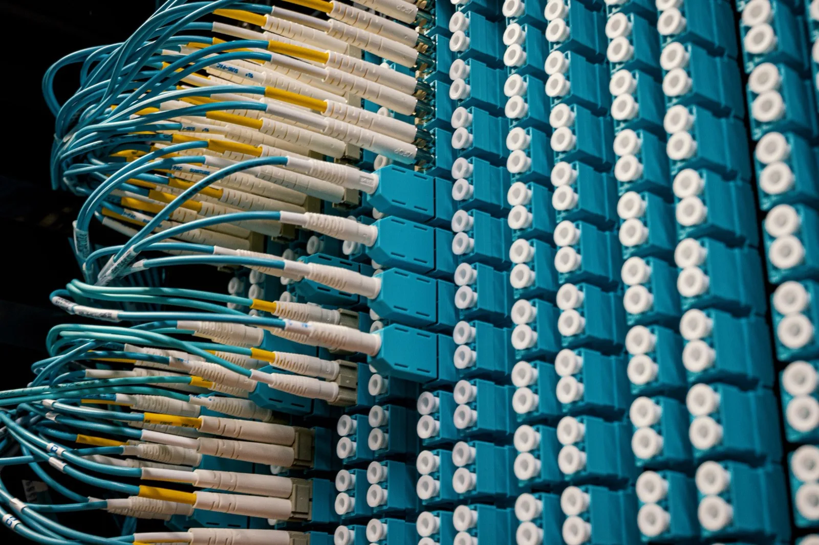 Fiber patch panel with turquoise and yellow patch cords