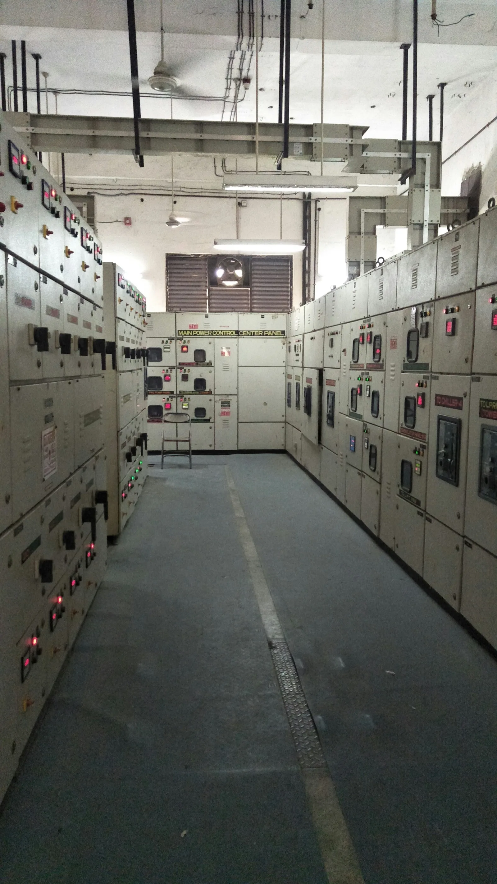 Switchgear room with two rows of panels and a central aisle